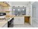 Open kitchen area with stylish wooden countertops, stone accent, and modern lighting at 4053 Overland Trl, Snellville, GA 30039