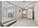 View of the open-concept living room with a bar area, tile flooring, and a ceiling fan at 4053 Overland Trl, Snellville, GA 30039