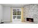 Living room featuring a cozy fireplace, stone accent wall, and sliding door to balcony at 4053 Overland Trl, Snellville, GA 30039