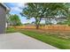 Large, newly fenced backyard with green grass and a concrete patio, perfect for outdoor enjoyment at 11204 Cornerstone Way, Hampton, GA 30228