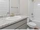 Clean bathroom featuring a granite countertop, white cabinets, and a shower-tub combination at 11204 Cornerstone Way, Hampton, GA 30228