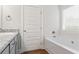 Bathroom features a bathtub, granite counters, grey cabinets, bronze fixtures and natural light from a window at 11204 Cornerstone Way, Hampton, GA 30228