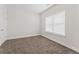 Cozy bedroom with carpeted floors, neutral paint, and a large window for natural light at 11204 Cornerstone Way, Hampton, GA 30228