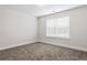Cozy bedroom features one window offering natural light, neutral colored walls, and soft, plush carpeting at 11204 Cornerstone Way, Hampton, GA 30228