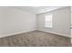 Cozy bedroom features plush carpeting, bright walls, and a window for natural light at 11204 Cornerstone Way, Hampton, GA 30228