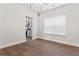 Open dining space with wood floors, a modern chandelier, and views into the kitchen at 11204 Cornerstone Way, Hampton, GA 30228