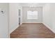 Bright dining room with modern chandelier, large window and dark wood floors at 11204 Cornerstone Way, Hampton, GA 30228