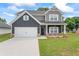 Beautiful two-story home featuring a gray color scheme, well-kept lawn, and two-car garage at 11204 Cornerstone Way, Hampton, GA 30228