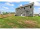 View of the home's gray vinyl siding, a fenced yard and a grassy lawn at 11204 Cornerstone Way, Hampton, GA 30228
