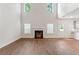 Bright, open living room with high ceilings, fireplace, fan, and lots of windows at 11204 Cornerstone Way, Hampton, GA 30228
