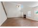 Open living room with staircase, fireplace, fan, and lots of natural light at 11204 Cornerstone Way, Hampton, GA 30228