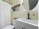 Well lit bathroom with a vanity, shower with curtain, and wood-look accents at 136 Huntcliff Trl, Ellenwood, GA 30294