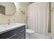 Bright bathroom featuring navy vanity, quartz countertop, and modern gold fixtures at 136 Huntcliff Trl, Ellenwood, GA 30294