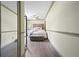 Hallway view of a bedroom featuring wood-look floors and neutral paint at 136 Huntcliff Trl, Ellenwood, GA 30294