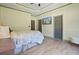 Cozy bedroom with unique wall paneling, soft colors, and hardwood flooring at 136 Huntcliff Trl, Ellenwood, GA 30294