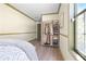 Bedroom featuring wood-look floors, neutral paint, and a clothing rack at 136 Huntcliff Trl, Ellenwood, GA 30294