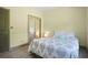 Bedroom featuring wood-look floors, neutral paint, and closet with mirrored doors at 136 Huntcliff Trl, Ellenwood, GA 30294