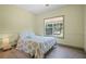 Bedroom featuring wood-look floors, neutral paint, and a large window overlooking the landscape at 136 Huntcliff Trl, Ellenwood, GA 30294