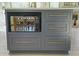 Stylish kitchen island features a built-in microwave and ample storage space with sleek hardware at 136 Huntcliff Trl, Ellenwood, GA 30294