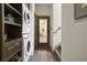 Interior shot of laundry area with stackable washer and dryer and built-in storage shelves at 136 Huntcliff Trl, Ellenwood, GA 30294