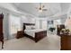 Spacious main bedroom with tray ceiling, neutral carpet and walls, and large windows at 3377 Aberrone Pl, Buford, GA 30519