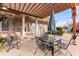 Inviting patio area complete with a pergola, outdoor seating, and brick facade at 3377 Aberrone Pl, Buford, GA 30519