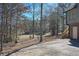 Backyard view from the side of the house, with trees and access to the golf course at 9001 East Carroll Rd, Winston, GA 30187