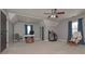 Spacious bonus room with vaulted ceilings, a ceiling fan, and two windows with blue curtains at 9001 East Carroll Rd, Winston, GA 30187