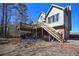 Side view of the home with a deck, access to the yard, and a driveway at 9001 East Carroll Rd, Winston, GA 30187
