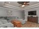 Inviting living room features a large sectional sofa, wood floors, and a ceiling fan at 9001 East Carroll Rd, Winston, GA 30187