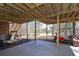 Outdoor patio with wooden beams, lighting, staircase, and space for parking golf cart at 9001 East Carroll Rd, Winston, GA 30187