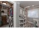 Walk-in closet featuring custom shelving, storage baskets, clothing rods and natural light at 9001 East Carroll Rd, Winston, GA 30187