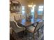 Large dining table with seating for eight and overhead chandelier at 171 Gorham Gates Dr, Hiram, GA 30141