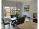 Bright and airy dining area with a window and modern chandelier at 3032 Farm Tract Trl, Woodstock, GA 30189