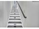 Contemporary staircase with black and white risers and illuminated steps at 5292 Greenway Dr, Villa Rica, GA 30180