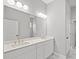 Bathroom featuring double sinks, quartz countertops, and a large vanity mirror at 1101 Cooks Farm Way, Woodstock, GA 30189