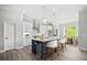 Modern kitchen with white cabinets, stainless steel appliances, a center island, and an adjacent dining area at 1101 Cooks Farm Way, Woodstock, GA 30189