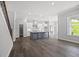 Living room flows into kitchen with island and modern pendant lighting at 1101 Cooks Farm Way, Woodstock, GA 30189