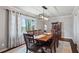 Traditional dining room with wood table, decorative light fixture, large window and gray walls at 1740 Starlight Dr, Marietta, GA 30062