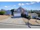 Attractive two-story home featuring an attached garage, extended driveway, and well-kept lawn at 537 Autumn Ridge Dr, Canton, GA 30115