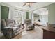 Spacious main bedroom featuring an archway to a sitting area, two recliners, and a large window at 537 Autumn Ridge Dr, Canton, GA 30115