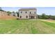 Spacious backyard featuring a well-maintained lawn and a covered patio with glass doors for seamless indoor-outdoor living at 7525 Homer Dr, Cumming, GA 30028