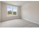 Clean and bright bedroom with gray carpet, fresh paint, and plenty of natural light at 7525 Homer Dr, Cumming, GA 30028