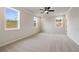 Spacious bedroom featuring neutral carpet, ceiling fan, recessed lighting, and three bright, double-hung windows at 7525 Homer Dr, Cumming, GA 30028