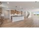 Bright open-concept kitchen features modern cabinets, granite countertops, and stainless steel appliances at 7525 Homer Dr, Cumming, GA 30028
