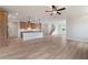 Spacious living room with a modern kitchen, hardwood floors, and staircase, perfect for entertaining and comfortable living at 7525 Homer Dr, Cumming, GA 30028