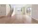 Bright living room with a staircase, wood flooring, and sliding glass doors at 7525 Homer Dr, Cumming, GA 30028