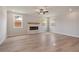 Open living room with a modern fireplace, bright natural light, and neutral walls at 7525 Homer Dr, Cumming, GA 30028