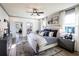 Spacious main bedroom with soft, modern décor, stylish furniture, and a picturesque view from the many windows at 7525 Homer Dr, Cumming, GA 30028