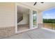 View of the covered patio and backyard through sliding glass doors to the open-concept living space at 7525 Homer Dr, Cumming, GA 30028